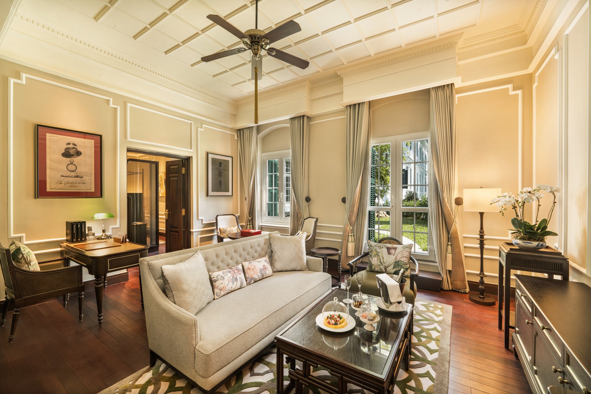 The living room of a heritage suite at the Metropole, with tall shuttered windows